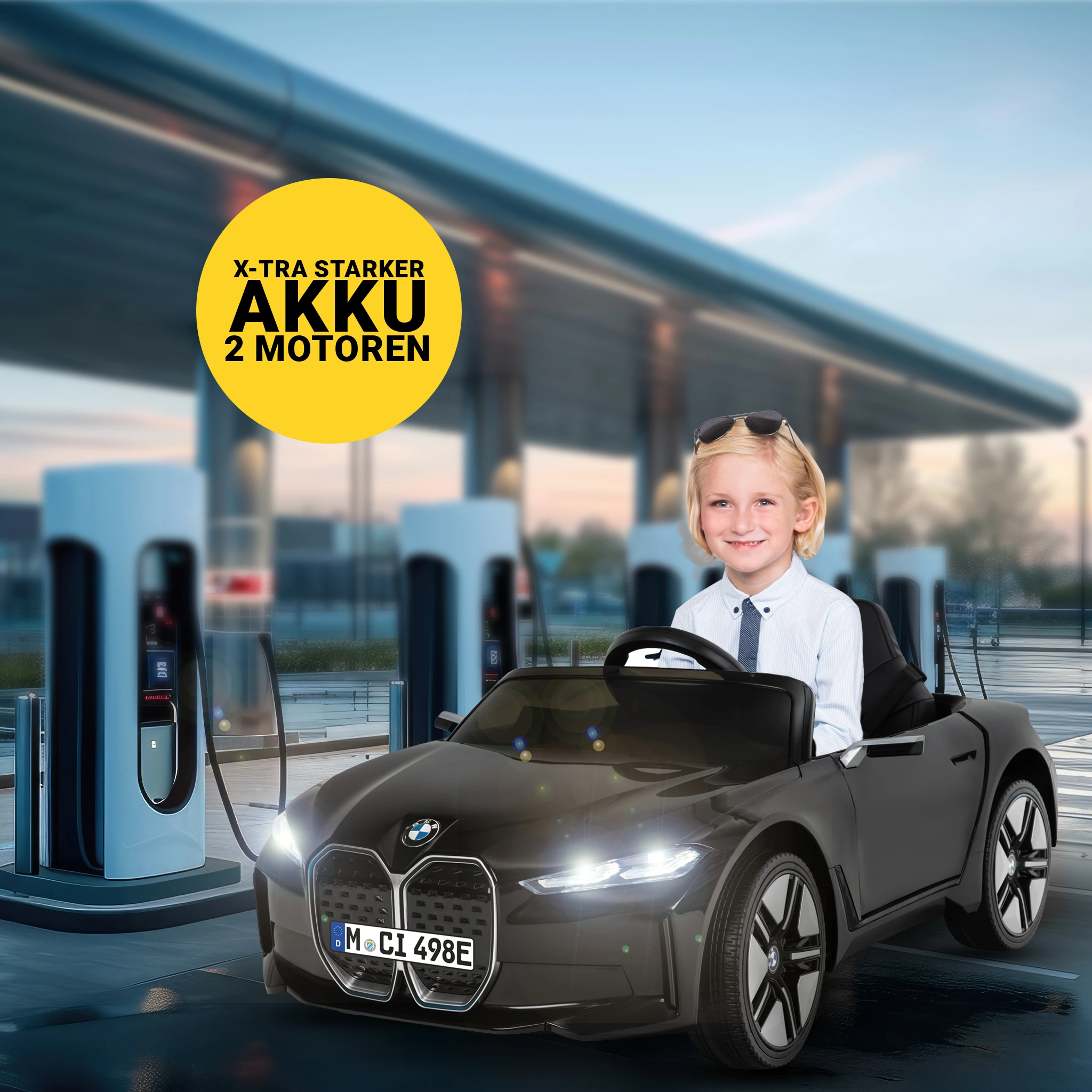 Extra starker Akku und zwei Motoren Junge sitzt einem BMW-Kinderauto vor Ladesäulen