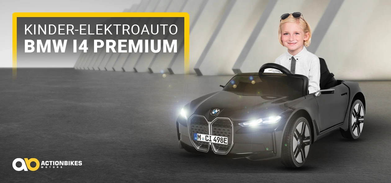 Actionbikes Kinder-Elektroauto BMW i4 Premium Lächelnder Junge steuert das Kinder-Elektroauto BMW i4 Premium